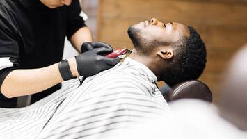 photo of black man getting a hair cut in barber shop