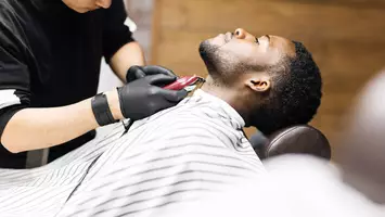 photo of black man getting a hair cut in barber shop