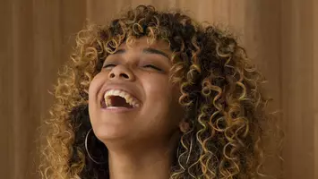 woman with bangs and frizzy curly hair