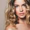 woman with medium length curled blonde hair