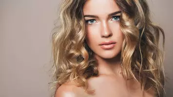 woman with medium length curled blonde hair