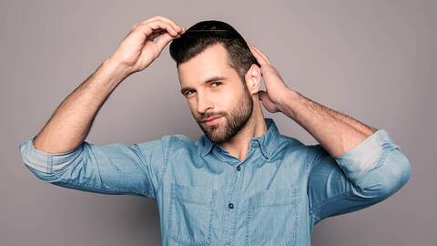 photo of man styling hair with comb