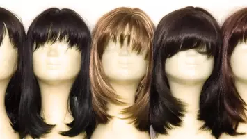 heads with wigs on them