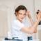 photo of woman using hairspray