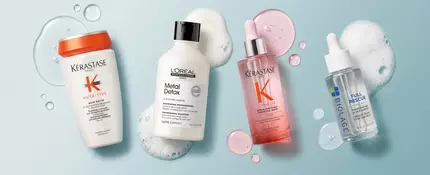 Hair products displayed to protect hair from sun damage, including serums from Pureology and Kerastase.
