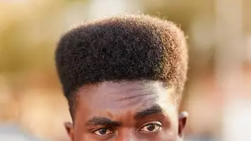 photo of man with high top 1990's mens hairstyle