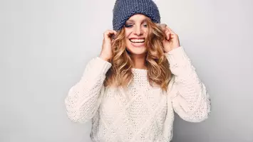 photo of woman with blonde hair wearing hat