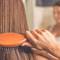 close up photo of woman brushing her hair
