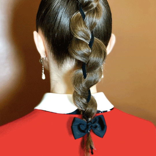 back of woman with red carpet braid