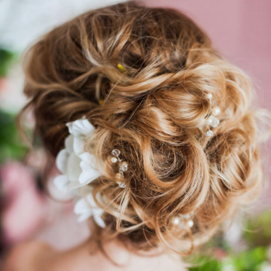 woman with a curly hair updo 