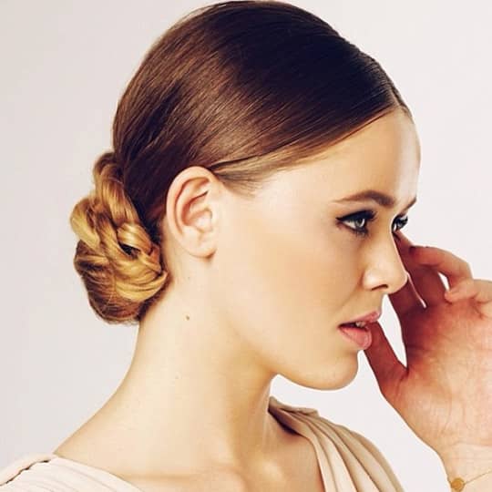 Photo of woman with a braided slick chignon