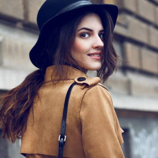 Woman with long ponytail in floppy big hat
