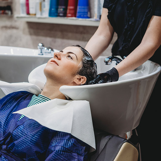 woman getting her hair washed at the salon