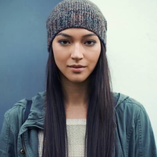 Woman with long straight hair wearing hat