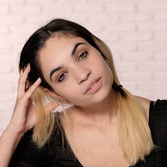woman holding hand in head showing hairline