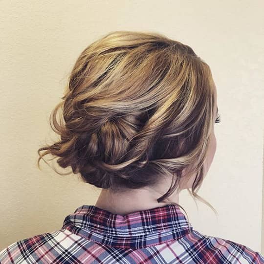 woman with widswept updo hairstyle