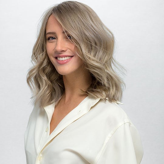 a woman with shoulder-length ash blonde hair