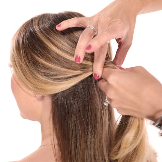 hand holding half a woman's hair