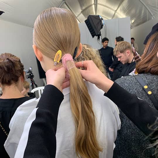 woman with low ponytail at paris fashion week