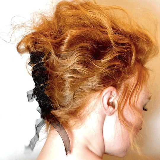 back of hair with black bow red carpet french twist