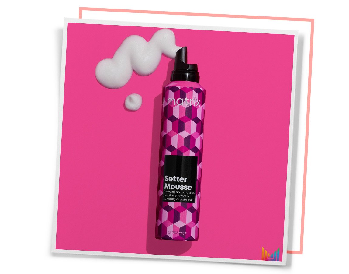 Close-up of a professional hair mousse formula by L’Oréal, highlighting its sleek packaging and luxurious texture for styling. Image 3