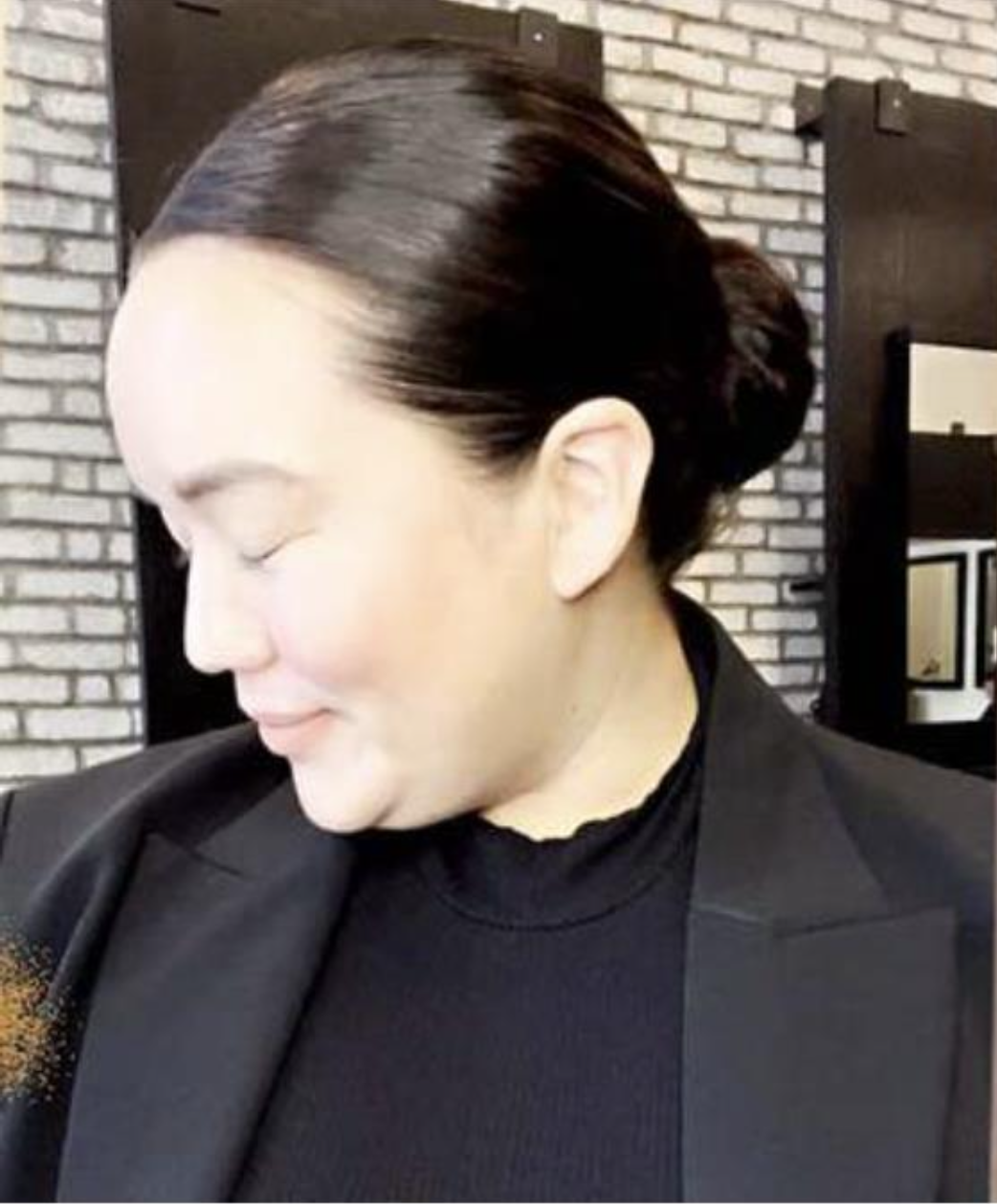 woman modeling sleek low bun hairstyle from tutorial