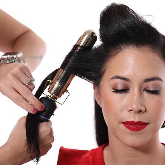 hair wrapped around curling iron for old hollywood waves style